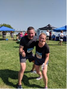 VIBE coach Jeff Herro smiles with a client who recently completed a 5K